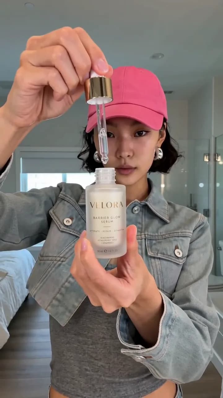Creator holding a serum dropper, from the Velora skincare demo ad